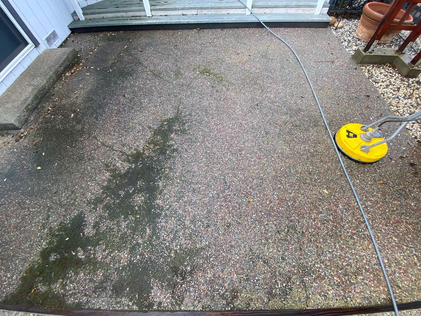 Santa Cruz patio before being pressure washed to remove grime.