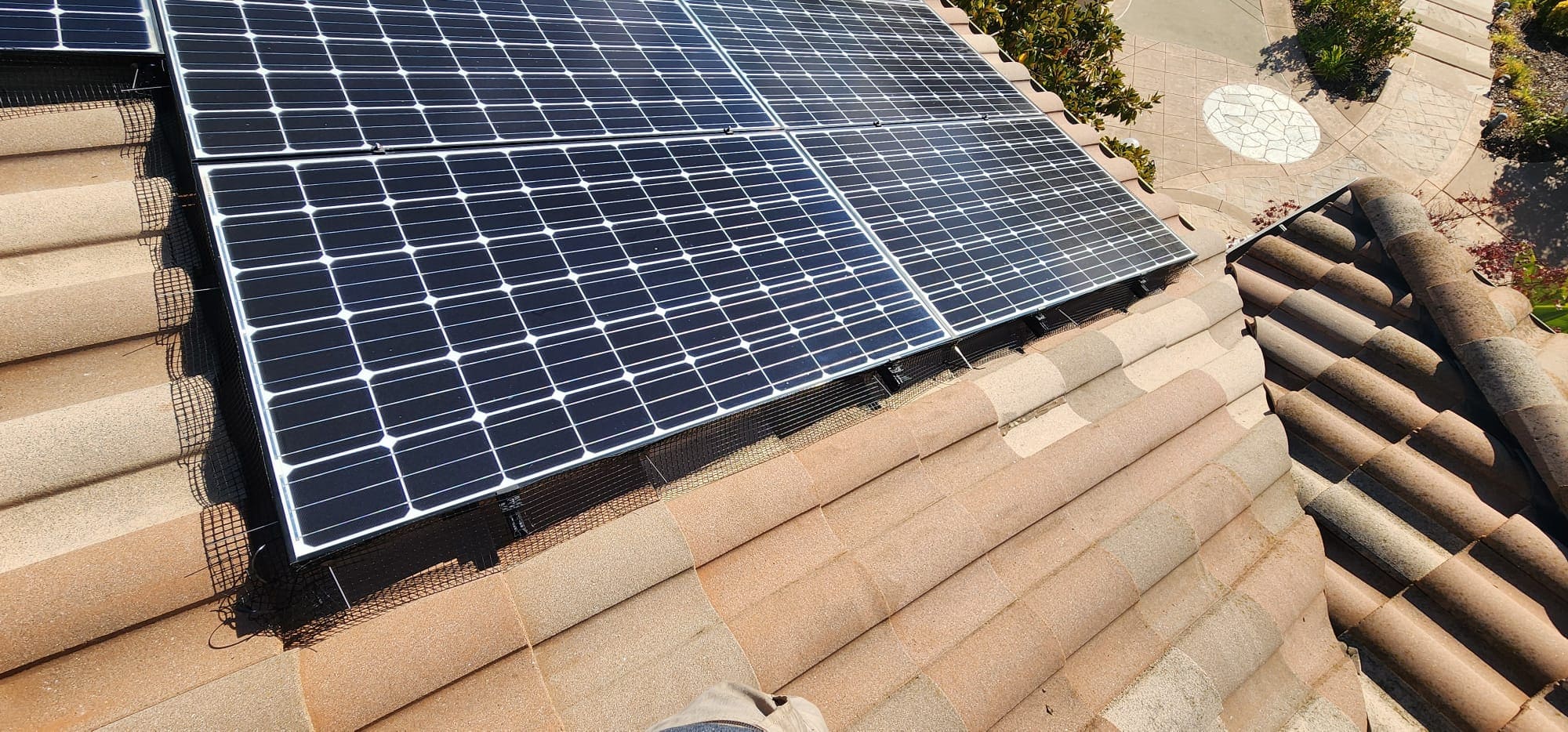 Bird-proofing mesh installed under solar panels in Dublin, CA.