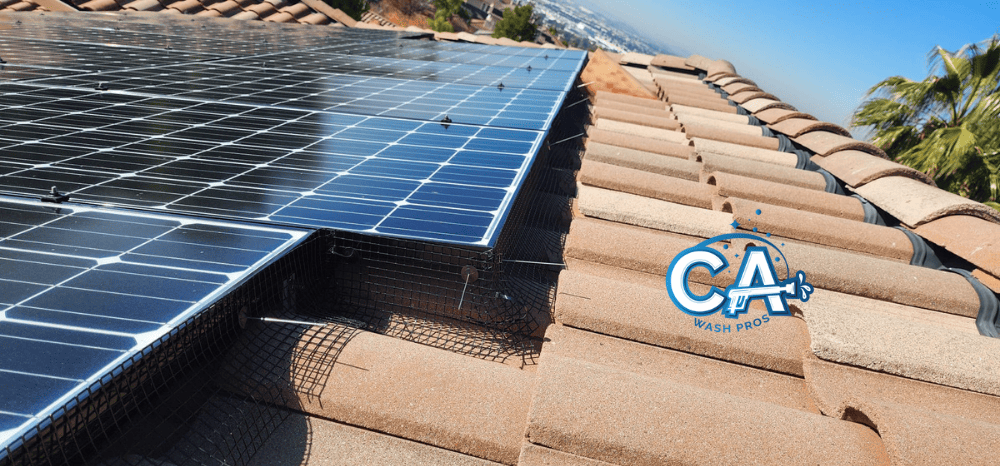 Bird barrier protecting rooftop solar panels from pigeons in San Leandro, CA.